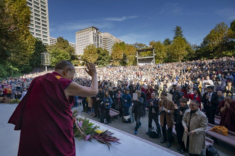 His Holiness the Dalai Lama waving to the crowd as he arrives on stage at the Hibiya Open-Air Concert Hall for his public talk on "One - We are One Family" in Tokyo, Japan on November 17, 2018. Photo by Tenzin Choejor