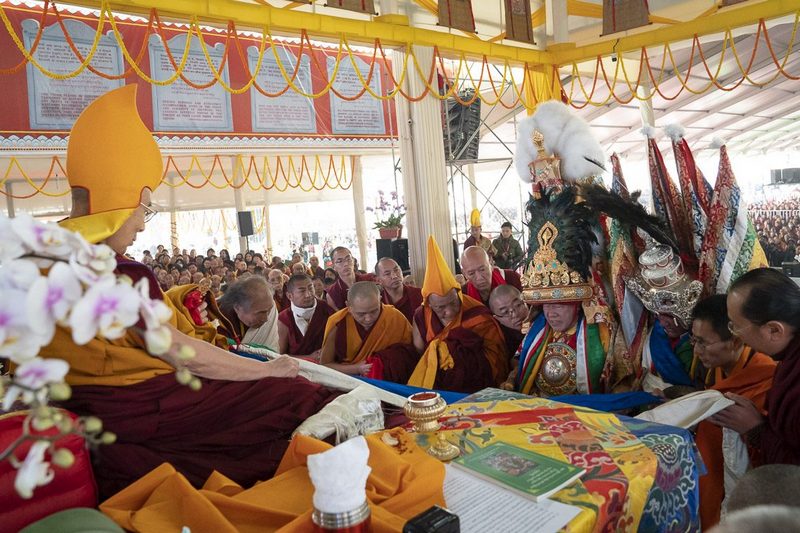 The oracle of Nechung Dorje Drakden approaches His Holiness the Dalai Lama during the Long Life Ceremony at the Kalachakra Ground in Bodhgaya, Bihar, India on December 31, 2018. Photo by Lobsang Tsering