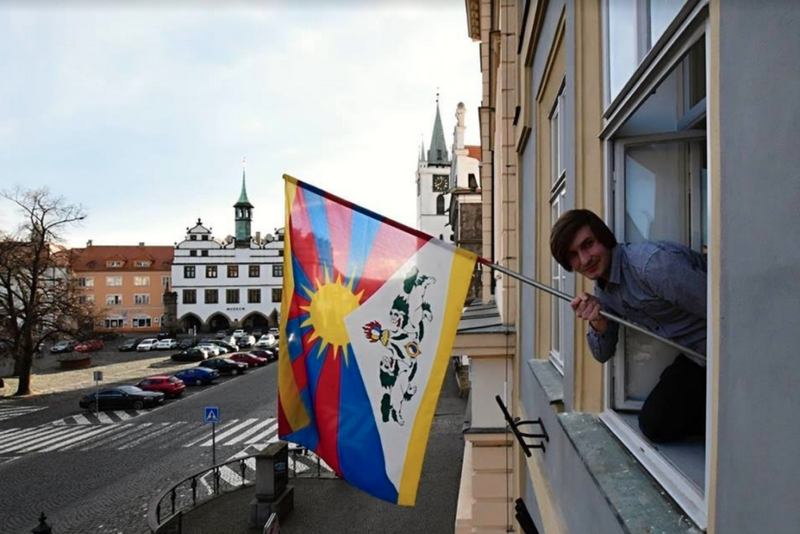 A supporter flying Tibetan flag in Litomerice, Czech Republic. Photo: Tibet Bureau Geneva